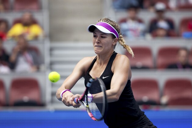 Eugenie Bouchard of Canada hits a return shot against Andrea Petkovic of Germany during their first round of the China Open tennis tournament at the National Tennis Stadium in Beijing, Monday, Oct. 5, 2015. (AP Photo/Andy Wong)