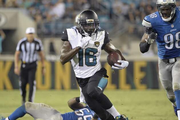 Jacksonville Jaguars running back Denard Robinson (16) rushes for yardage past Detroit Lions middle linebacker Stephen Tulloch (55) and defensive end Devin Taylor (98) during the first half of a preseason NFL football game in Jacksonville, Fla., Friday, Aug. 28, 2015. (AP Photo/Phelan M. Ebenhack)