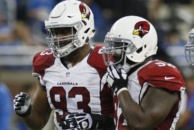 Arizona Cardinals defensive end Calais Campbell (93) waits with defensive end Frostee Rucker (92) during the second half of an NFL football game against the Detroit Lions, Sunday, Oct. 11, 2015, in Detroit. (AP Photo/Duane Burleson)