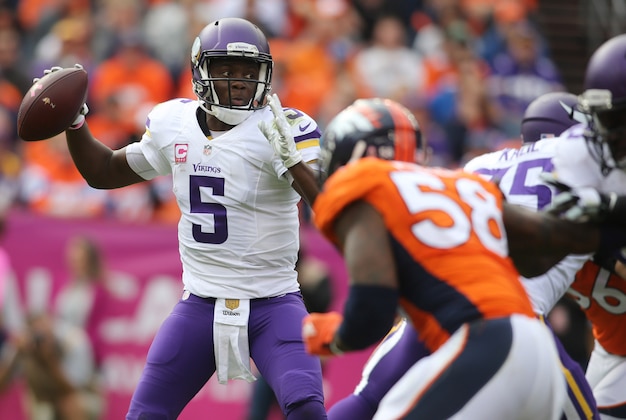 Oct 4, 2015; Denver, CO, USA; Minnesota Vikings quarterback Teddy Bridgewater (5) throws a pass during the first half against the Denver Broncos at Sports Authority Field at Mile High. Mandatory Credit: Chris Humphreys-USA TODAY Sports