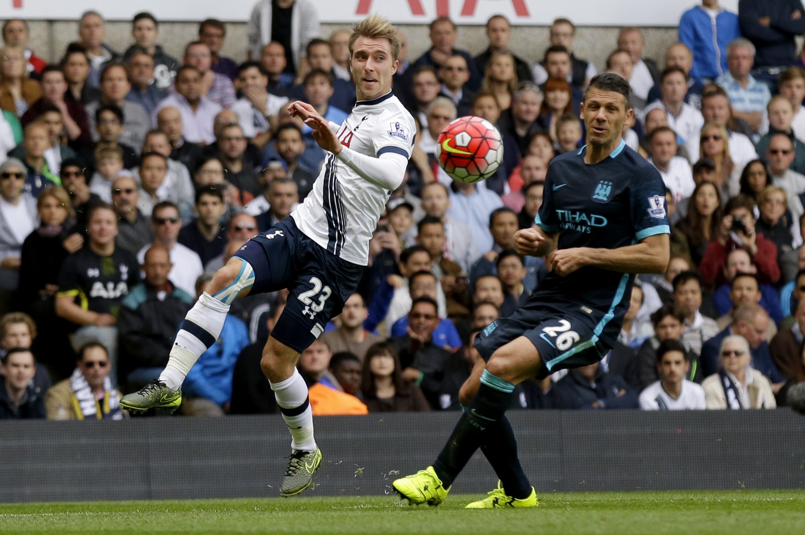 Tottenham Hotspur's Christian Eriksen, left, competes for the ball with Manchester City's Martin Demichelis during the English Premier League soccer match between Tottenham Hotspur and Manchester City at White Hart Lane stadium in London, Saturday, Sept. 26, 2015.  (AP Photo/Matt Dunham)