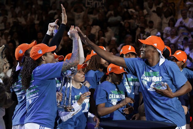 Minnesota Lynx center Sylvia Fowles, right, named most valuable player celebrates after beating the Indiana Fever 69-52 in Game 5 of the WNBA basketball finals, Wednesday, Oct. 14, 2015, in Minneapolis. (AP Photo/Jim Mone)