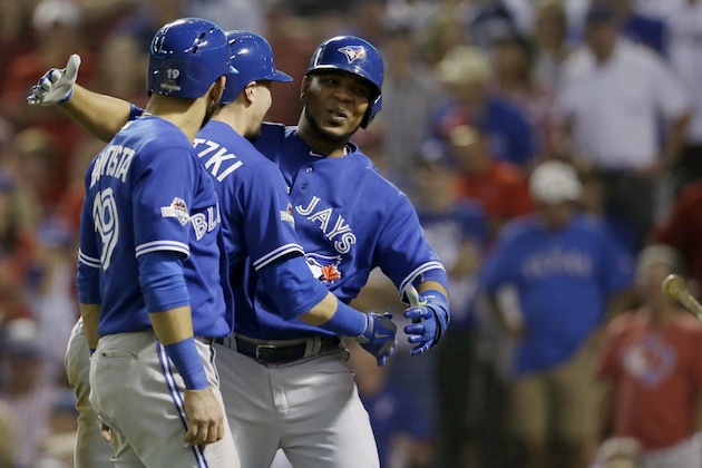 After hitting a three-run home run against the Texas Rangers, Toronto Blue Jays shortstop Troy Tulowitzki, center celebrates with right fielder Jose Bautista (19), and designated hitter Edwin Encarnacion (10), right, during the sixth inning in Game 3 of baseball's American League Division Series Sunday, Oct. 11, 2015, in Arlington, Texas. (AP Photo/LM Otero)