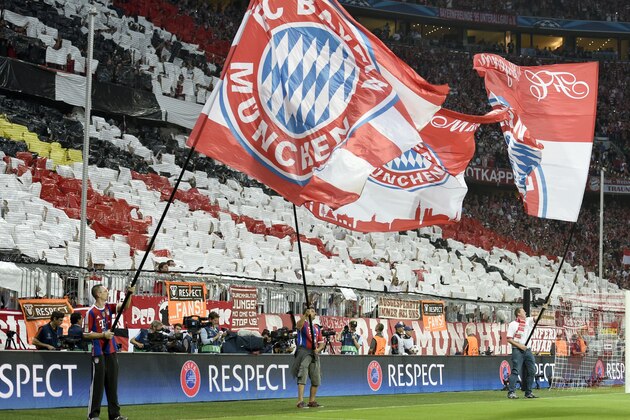 Munich's fans hold their team's flags before the UEFA Champions League football match semi final FC Bayern Munich vs FC Barcelona in Munich on May 12, 2015.  AFP PHOTO / ODD ANDERSEN        (Photo credit should read ODD ANDERSEN/AFP/Getty Images)