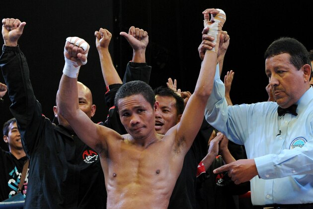 World Boxing Organization light-flyweight champion Donnie Nietes (C) of the Philippines celebrates after defeating Mexican challenger Felipe Salguero on June 2, 2012 during a WBO light-flyweight title bout in Manila, retaining his title.               AFP PHOTO / Jay DIRECTO        (Photo credit should read JAY DIRECTO/AFP/GettyImages)