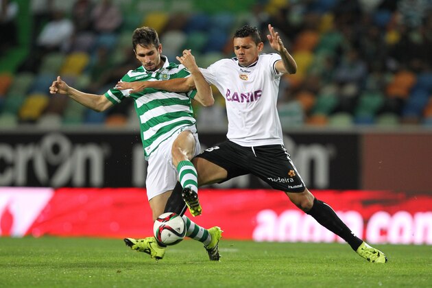 LISBON, PORTUGAL - SEPTEMBER 21: Sporting's defender Paulo Oliveira vies with Nacional's forward Tiquinho Soares during the match between Sporting CP and FC CD Nacional at Jose Alvalade Satdum on September 21 2015 in Lisbon, Portugal.  (Photo by Carlos Rodrigues/Getty Images)