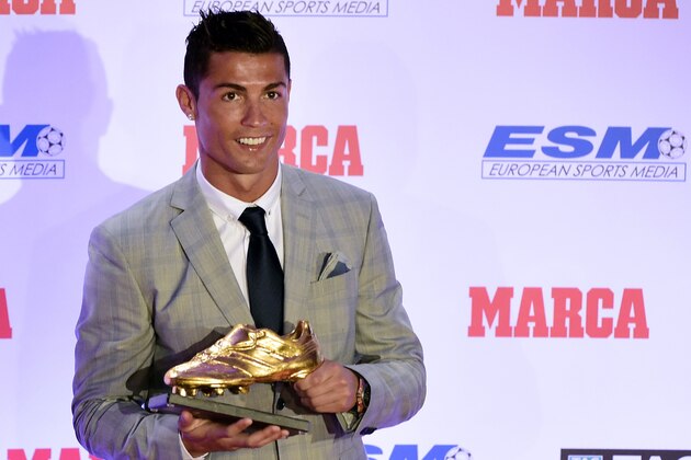 Real Madrid's Portuguese forward Cristiano Ronaldo poses with his fourth European Golden Shoe in Madrid, on October 13, 2015. Cristiano, who ended the season with 48 goals from 35 appearances, won the Golden Shoe in 2008 while he was at Manchester United, in 2011 with Real Madrid and shared it with Luis Suarez last year. AFP PHOTO / JAVIER SORIANO        (Photo credit should read JAVIER SORIANO/AFP/Getty Images)