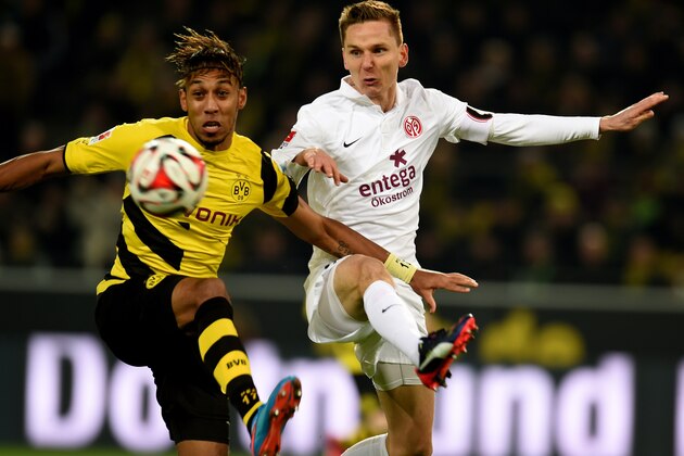 Mainz' defender Niko Bungert (R) and Dortmund's Gabonese striker Pierre-Emerick Aubameyang vie for the ball  during the German first division Bundesliga football match Borussia Dortmund v 1 FSV Mainz 05 in Dortmund, Germany, on February 13, 2015.  AFP PHOTO /  PATRIK STOLLARZ

DFL RULES TO LIMIT THE ONLINE USAGE DURING MATCH TIME TO 15 PICTURES PER MATCH. IMAGE SEQUENCES TO SIMULATE VIDEO IS NOT ALLOWED AT ANY TIME. FOR FURTHER QUERIES PLEASE CONTACT DFL DIRECTLY AT + 49 69 650050.        (Photo credit should read PATRIK STOLLARZ/AFP/Getty Images)
