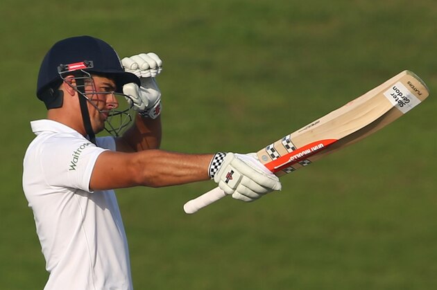England's Alastair Cook celebrates after scoring 150 runs during the third day's play of the first cricket Test match between Pakistan and England at The Sheikh Zayed International Cricket Stadium in Abu Dhabi on October 15, 2015. AFP PHOTO / MARWAN NAAMANI        (Photo credit should read MARWAN NAAMANI/AFP/Getty Images)