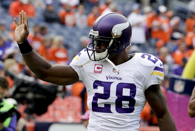 Minnesota Vikings running back Adrian Peterson waves during warms ups before an NFL football game against the Denver Broncos Sunday, Oct. 4, 2015, in Denver. (AP Photo/Joe Mahoney)