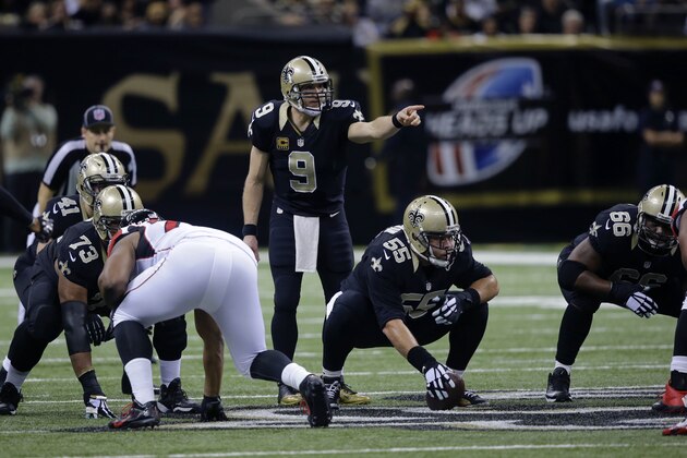 New Orleans Saints quarterback Drew Brees (9) calls an audible at the line of scrimmage in the first half of an NFL football game against the Atlanta Falcons in New Orleans, Sunday, Dec. 21, 2014. (AP Photo/Bill Haber)