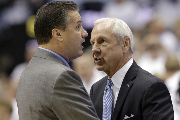Kentucky coach John Calipari, left, and North Carolina coach Roy Williams speak before an NCAA college basketball game in Chapel Hill, N.C., Saturday, Dec. 14, 2013. (AP Photo/Gerry Broome)