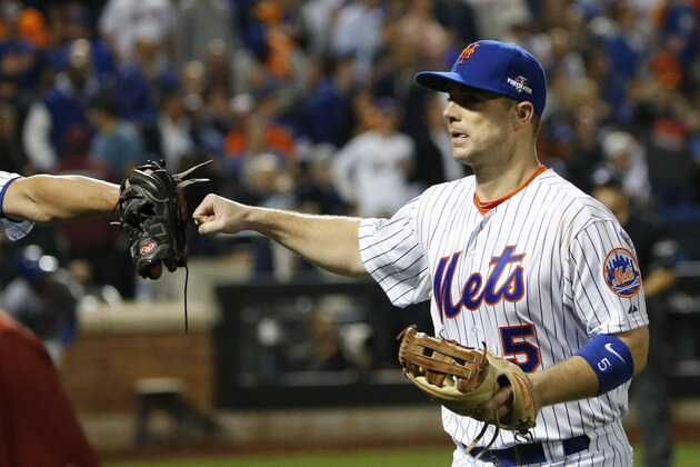 New York Mets third baseman David Wright (5) gets a fist bump from a teammate after making an out of bounds catch on a foul ball against the Los Angeles Dodgers to end the top of the eighth inning of baseball's Game 4 of the National League Division Series, Tuesday, Oct. 13, 2015, in New York. (AP Photo/Kathy Willens)