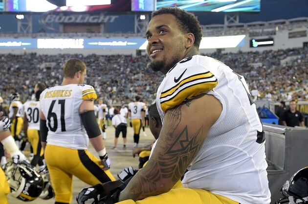 Pittsburgh Steelers center Maurkice Pouncey, right, watches from the bench during the first half of an NFL preseason football game against the Jacksonville Jaguars in Jacksonville, Fla., Friday, Aug. 14, 2015. (AP Photo/Phelan M. Ebenhack)