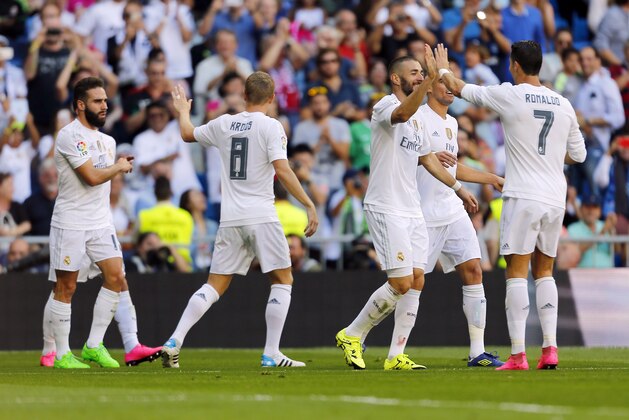 Real Madrid's Karim Benzema, second right, celebrates with teammate Cristiano Ronaldo, right, after he scored against Granada during a Spanish La Liga soccer match between Real Madrid and Granada at the Santiago Bernabeu stadium in Madrid, Saturday, Sept. 19, 2015. Benzema scored once in Real Madrid's 1-0 victory. (AP Photo/Francisco Seco)