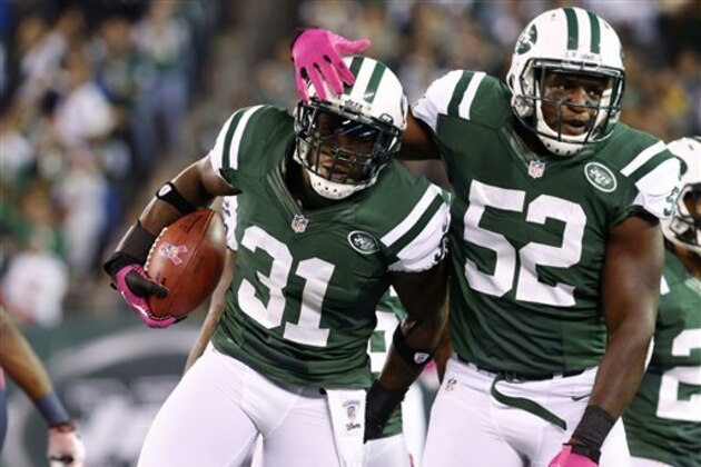 New York Jets cornerback Antonio Cromartie (31) celebrates with linebacker David Harris (52) after intercepting a pass during the first half of an NFL football game against the Houston Texans, Monday, Oct. 8, 2012, in East Rutherford, N.J. (AP Photo/Julio Cortez)
