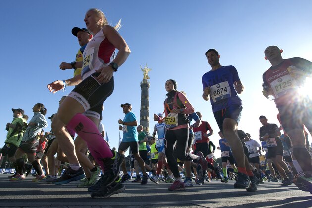 Runners pass by the Victory Column as they start the 42nd Berlin Marathon in front of the Brandenburg Gate in Berlin, Germany, Sunday, Sept. 27, 2015. Some 40,000 runners took part in the event. (AP Photo/Michael Sohn)