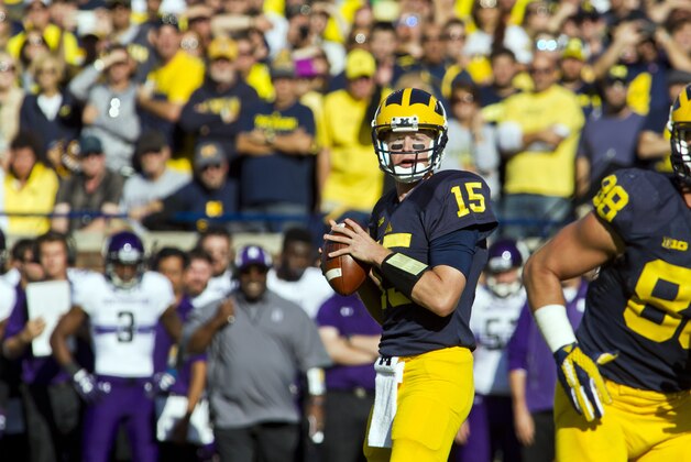 Michigan quarterback Jake Rudock (15) handles the ball looking for a receiver to throw a pass to in the first quarter of an NCAA college football game against Northwestern in Ann Arbor, Mich., Saturday, Oct. 10, 2015. (AP Photo/Tony Ding)
