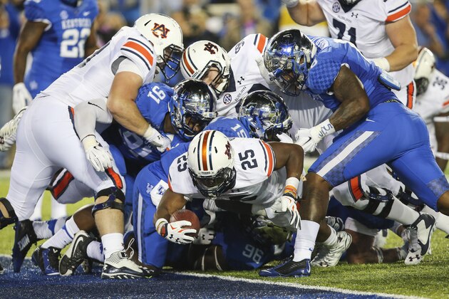 Auburn running back Peyton Barber gets the ball across the goal line for a touchdown during the second half of an NCAA college football game against Kentucky, Thursday, Oct. 15, 2015, in Lexington, Ky. Auburn won the game 30-27. (AP Photo/David Stephenson)