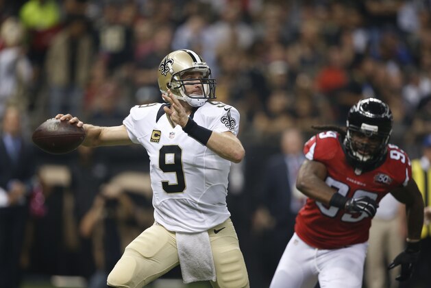 New Orleans Saints quarterback Drew Brees (9) works against the Atlanta Falcons during the first half of  an  NFL football game, Thursday, Oct. 15, 2015, in New Orleans. (AP Photo/Gerald Herbert)