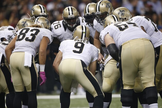 New Orleans Saints quarterback Drew Brees (9) speaks in huddle against the Atlanta Falcons during the first half of an NFL football game, Thursday, Oct. 15, 2015, in New Orleans. (AP Photo/Gerald Herbert)
