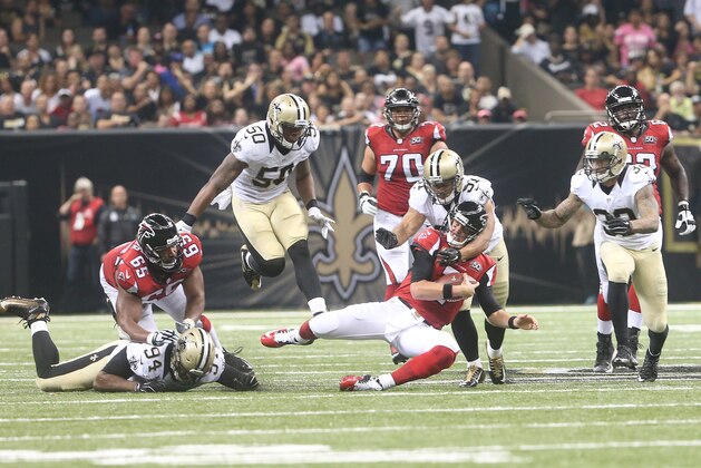 New Orleans Saints outside linebacker Kasim Edebali (91) hits Atlanta Falcons quarterback Matt Ryan (2) during the first half of an NFL football game, Thursday, Oct. 15, 2015, in New Orleans. (AP Photo/John Bazemore)
