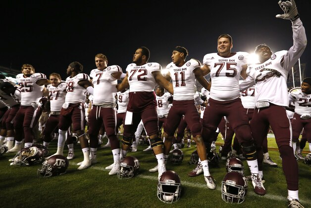Texas A&M players sing after they defeat Auburn 41-38 in an NCAA college football game on Saturday, Nov. 8, 2014, in Auburn, Ala. (AP Photo/Butch Dill)
