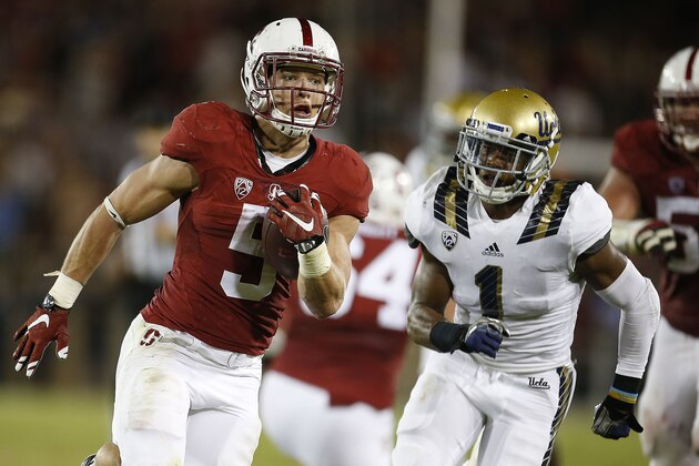 Stanford running back Christian McCaffrey (5) runs past UCLA defensive back Ishmael Adams (1) for a touchdown during the first half of an NCAA college football game Thursday, Oct. 15, 2015, Stanford, Calif. (AP Photo/Tony Avelar)