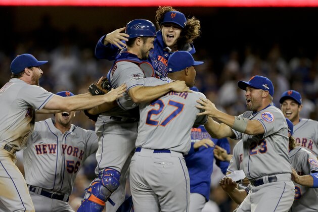 New York Mets starting pitcher Jacob deGrom, above right, catcher Travis d'Arnaud above left, and teammates celebrate their 3-2 win over the Los Angeles Dodgers in Game 5 of baseball's National League Division Series Thursday, Oct. 15, 2015, in Los Angeles. (AP Photo/Alex Gallardo)