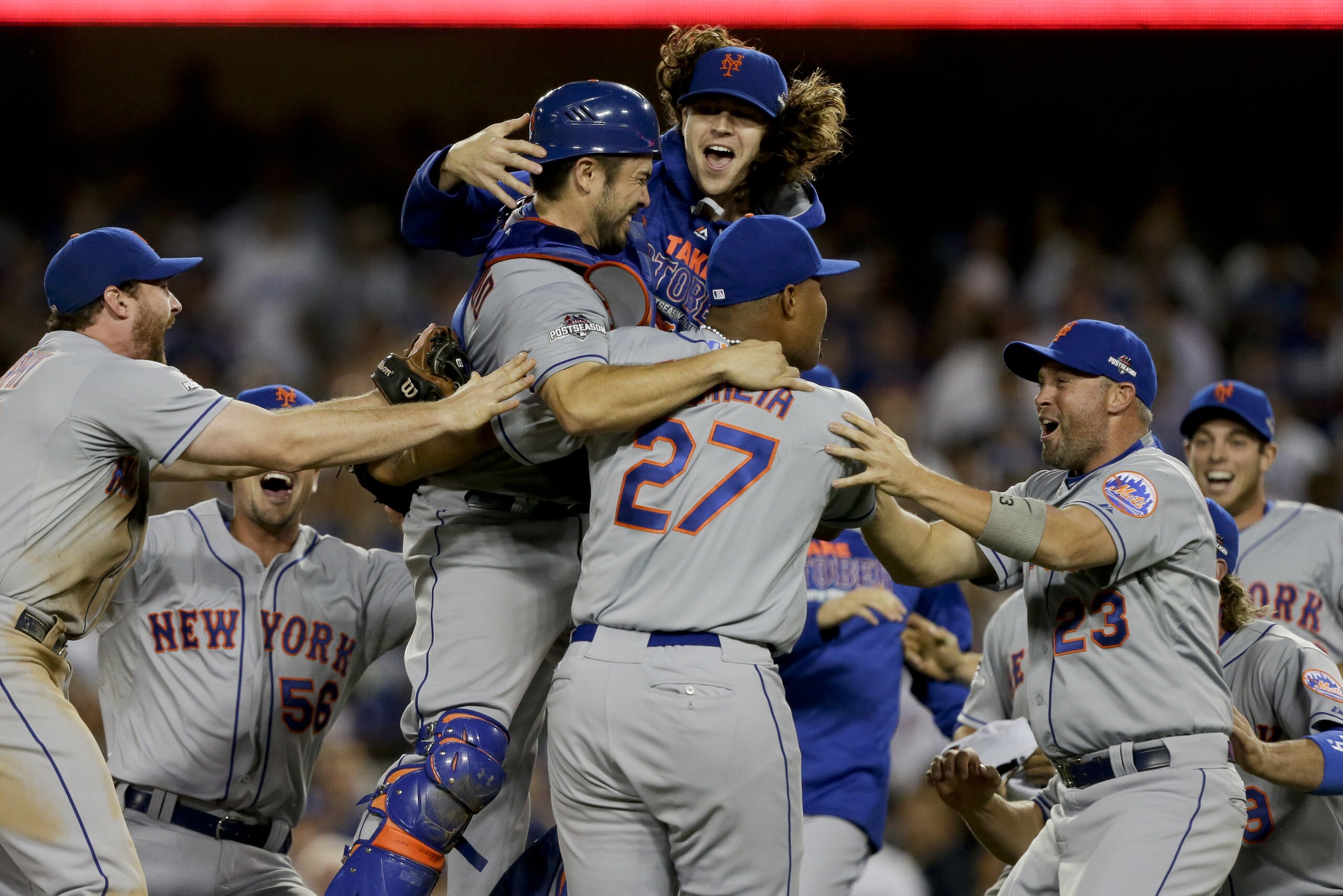 New York Mets starting pitcher Jacob deGrom, above right, catcher Travis d'Arnaud above left, and teammates celebrate their 3-2 win over the Los Angeles Dodgers in Game 5 of baseball's National League Division Series Thursday, Oct. 15, 2015, in Los Angeles. (AP Photo/Alex Gallardo)