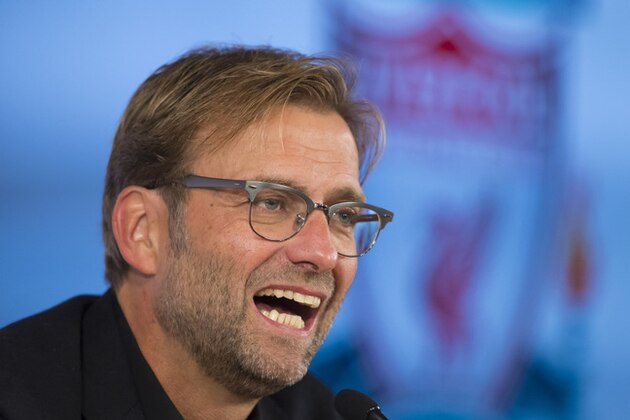 Liverpool's manager Juergen Klopp smiles as he speaks at a press conference after being appointed the club's new manager on a three-year deal, Liverpool, England, Friday, Oct. 9, 2015. The 48-year-old German has been out of work since May, when he ended a seven-year spell at Borussia Dortmund to take a sabbatical. (AP Photo/Jon Super)