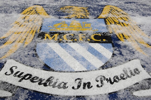 A club crest is covered in ice as Red Bull Salzburg train at the City of Manchester Stadium in Manchester, England, Tuesday Nov. 30, 2010, the day before their Europa League Group A soccer match on Wednesday against Manchester City. Snow has gripped the region in a wave of winter weather. (AP Photo/Jon Super)