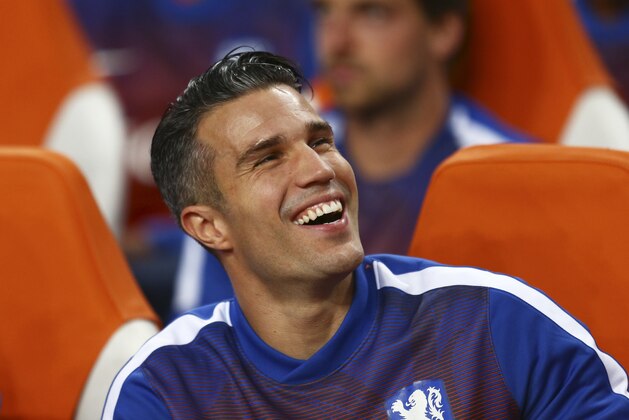 Substitute player Netherlands' Robin van Persie laughs as he waits for the start of the Euro 2016 qualifying soccer match between Netherlands and Iceland, at the ArenA stadium, in Amsterdam, Netherlands, Thursday, Sept. 3, 2015. Iceland won the match with a 1-0 score. (AP Photo/Peter Dejong)