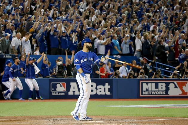 TORONTO, ON - OCTOBER 14:  Jose Bautista #19 of the Toronto Blue Jays flips his bat up in the air after he hits a three-run home run in the seventh inning against the Texas Rangers in game five of the American League Division Series at Rogers Centre on October 14, 2015 in Toronto, Canada.  (Photo by Tom Szczerbowski/Getty Images)