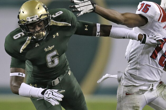 SMU wide receiver Jeremy Johnson (15) pushes off South Florida defensive back Lamar Robbins (6) after a reception during the third quarter of an NCAA college football game Saturday, Nov. 23, 2013, in Tampa, Fla. SMU won the game 16-6. (AP Photo/Chris O'Meara)