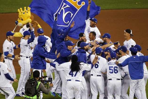 Kansas City Royals players celebrate on the field after their 7-2 win over the Houston Astros in Game 5 of baseball's American League Division Series, Wednesday, Oct. 14, 2015, in Kansas City, Mo.  (AP Photo/Colin E. Braley)