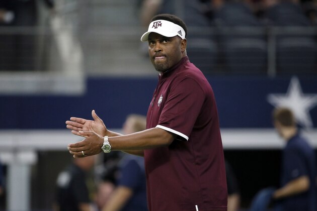 Texas A&M coach Kevin Sumlin applauds his team as players warm up for an NCAA college football game against Arkansas on Saturday, Sept. 26, 2015, in Arlington, Texas. (AP Photo/Tony Gutierrez)