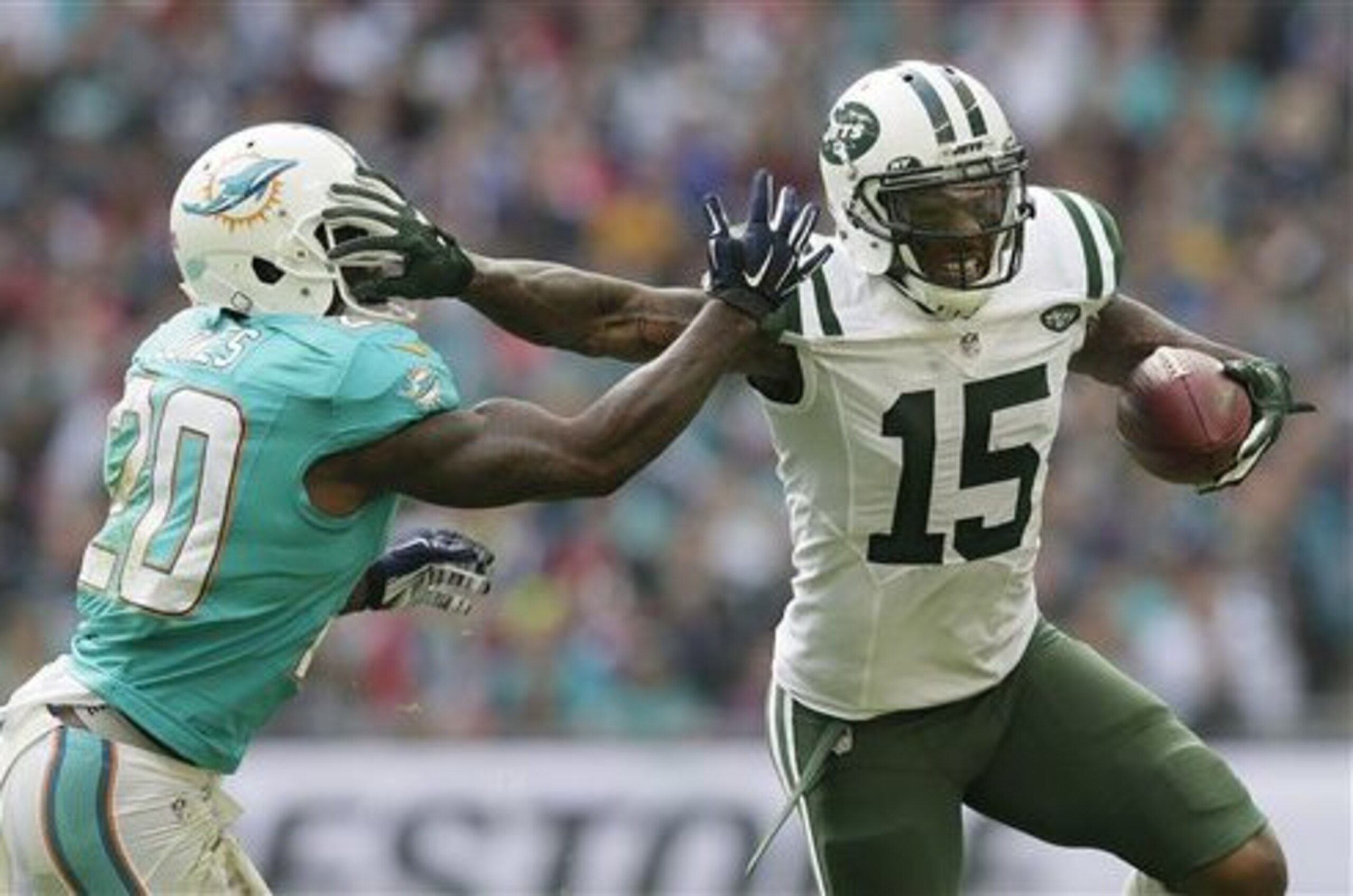 FILE - In this Oct. 4, 2015, file photo, New York Jets' Brandon Marshall, right, fends off Miami Dolphins' Reshad Jones during an NFL football game at Wembley stadium in London. Many of the familiar faces who switched teams may wish they stayed put. (AP Photo/Tim Ireland, File) FILE - In this Oct. 4, 2015, file photo, New York Jets' Brandon Marshall, right, fends off Miami Dolphins' Reshad Jones during an NFL football game at Wembley stadium in London. Many of the familiar faces who switched teams may wish they stayed put. (AP Photo/Tim Ireland, File)