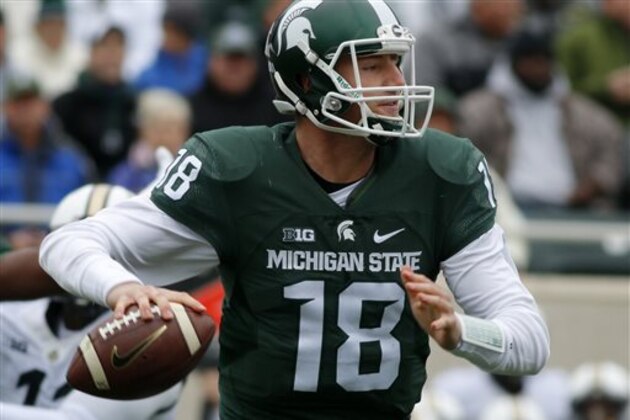 FILE - In this Oct. 3, 2015, file photo, Michigan State quarterback Connor Cook looks to throw against Purdue during the first quarter of an NCAA college football game in East Lansing, Mich. Michigan defenders Jabrill Peppers and Jourdan Lewis will pose quite a challenge for Connor Cook on Saturday. (AP Photo/Al Goldis)