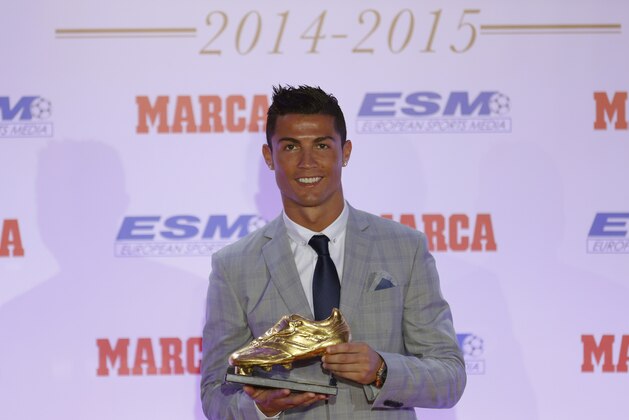 Real Madrid's striker Cristiano Ronaldo poses with the Golden Boot award for scoring the most goals in Europe's domestic leagues last season during a ceremony in Madrid, Spain Tuesday Oct. 13, 2015. This is the fourth Golden Boot award Ronaldo has won during his career and his third since joining Real Madrid, where he scored 48 goals during the last La Liga season. (AP Photo/Francisco Seco)