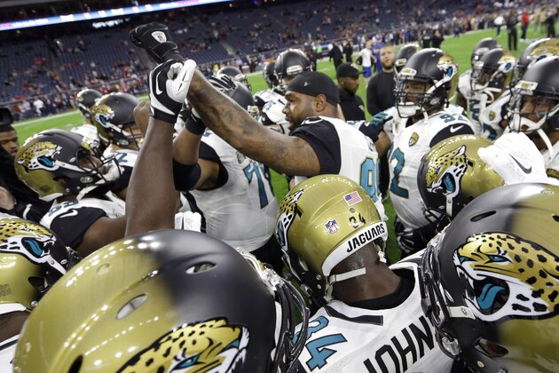 Jacksonville Jaguars players gather before an NFL football game against the Houston Texans Sunday, Dec. 28, 2014, in Houston. (AP Photo/David J. Phillip)