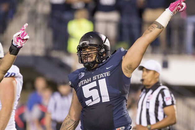 Oct 16, 2015; Logan, UT, USA; Utah State Aggies nose tackle David Moala (51) celebrates a fumble recovery against the Boise State Broncos during the first half at Romney Stadium. Mandatory Credit: Rob Gray-USA TODAY Sports