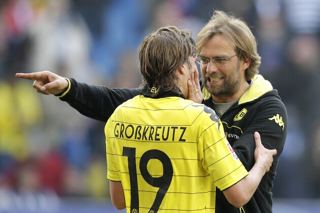 Dortmund's Kevin Grosskreutz, left, and coach Juergen Klopp, right, celebrate after the German first division Bundesliga soccer match between Hamburger SV and Borussia Dortmund  in Hamburg, Germany, Saturday, April 9, 2011. The match ended in a 1-1 draw. (AP Photo/Michael Sohn)  ** NO MOBILE USE UNTIL 2 HOURS AFTER THE MATCH, WEBSITE USERS ARE OBLIGED TO COMPLY WITH DFL-RESTRICTIONS, SEE INSTRUCTIONS FOR DETAILS **