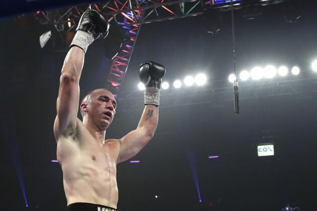 Sean Monaghan raises his arms as referee Tony Weeks stops the fight against Anthony Caputo-Smith in the third round during a light heavyweight fight, Saturday, Oct. 12, 2013, in Las Vegas. (AP Photo/Julie Jacobson)