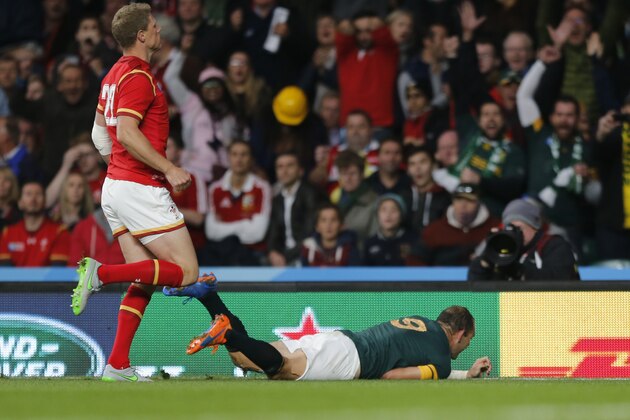South Africa's captain Fourie Du Preez scores a try during the Rugby World Cup quarterfinal match between South Africa and Wales at Twickenham Stadium, London, Saturday, Oct. 17, 2015. (AP Photo/Frank Augstein)