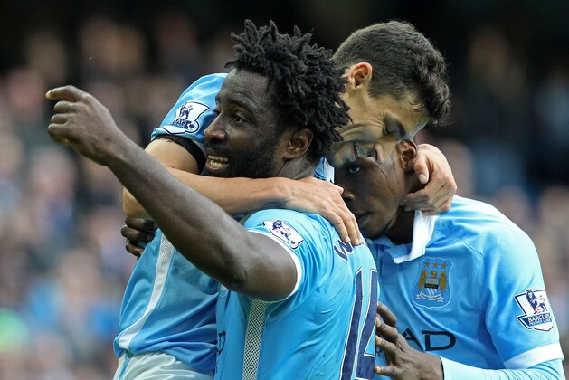Manchester City's Ivorian striker Wilfried Bony (L) celebrates with teammates after scoring their fifth goal of the English Premier League football match between Manchester City and Bournemouth at the Etihad Stadium in Manchester, northwest England, on October 17, 2015. Manchester City won the game 5-1. AFP PHOTO / LINDSEY PARNABY

RESTRICTED TO EDITORIAL USE. No use with unauthorized audio, video, data, fixture lists, club/league logos or 'live' services. Online in-match use limited to 75 images, no video emulation. No use in betting, games or single club/league/player publications.        (Photo credit should read LINDSEY PARNABY/AFP/Getty Images)