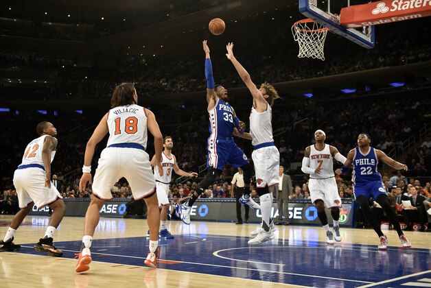Philadelphia 76ers forward Robert Covington (33) shoots over New York Knicks center Robin Lopez (8) during the first half of a preseason NBA basketball game on Monday, Oct. 12, 2015, in New York. (AP Photo/Kathy Kmonicek)