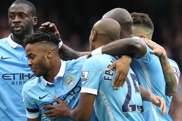 Manchester City's English midfielder Raheem Sterling (2nd L) celebrates with teammates after scoring the opening goal of the English Premier League football match between Manchester City and Bournemouth at the Etihad Stadium in Manchester, northwest England, on October 17, 2015.  AFP PHOTO / LINDSEY PARNABY

RESTRICTED TO EDITORIAL USE. No use with unauthorized audio, video, data, fixture lists, club/league logos or 'live' services. Online in-match use limited to 75 images, no video emulation. No use in betting, games or single club/league/player publications.        (Photo credit should read LINDSEY PARNABY/AFP/Getty Images)