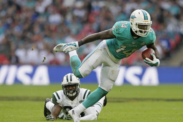 Miami Dolphins' Jarvis Landry breaks the challenge from New York Jets' Darrelle Revis during the NFL football game between the New York Jets and the Miami Dolphins and at Wembley stadium in London, Sunday, Oct. 4, 2015. (AP Photo/Tim Ireland)