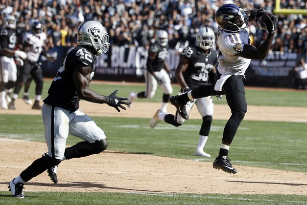 Baltimore Ravens' Kamar Aiken makes a catch against the Oakland Raiders during an NFL football game Sunday, Sept. 20, 2015, in Oakland , Calif. (AP Photo/Tony Avelar)